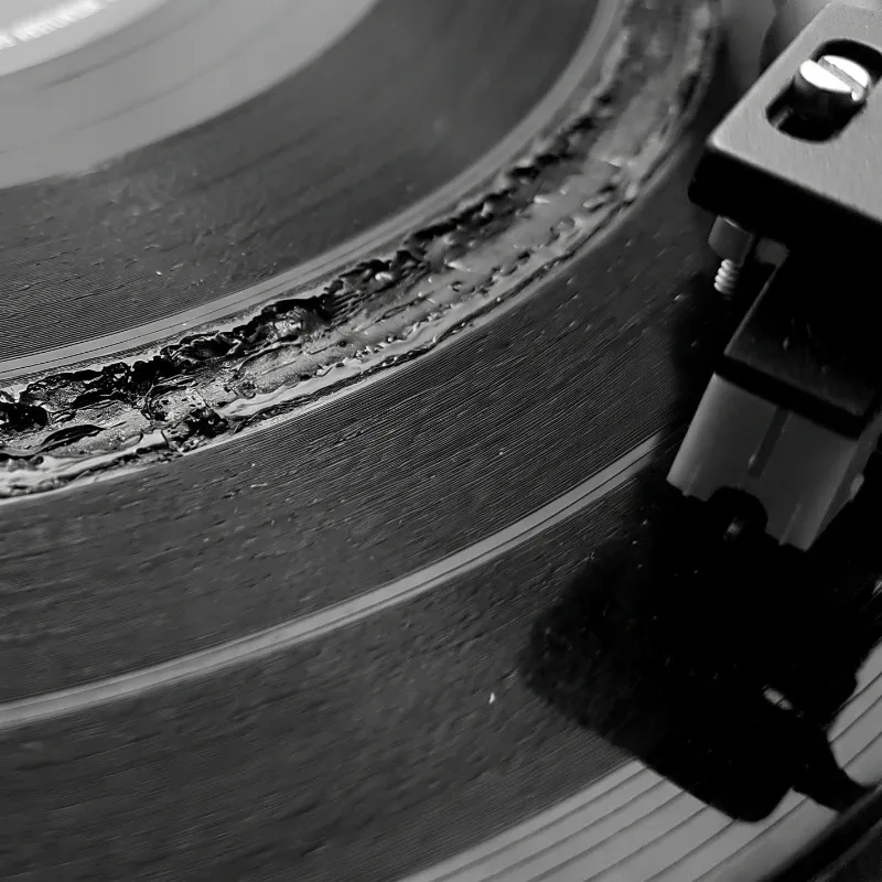 Microscopic groove burn and tracking distortion wear on vinyl record