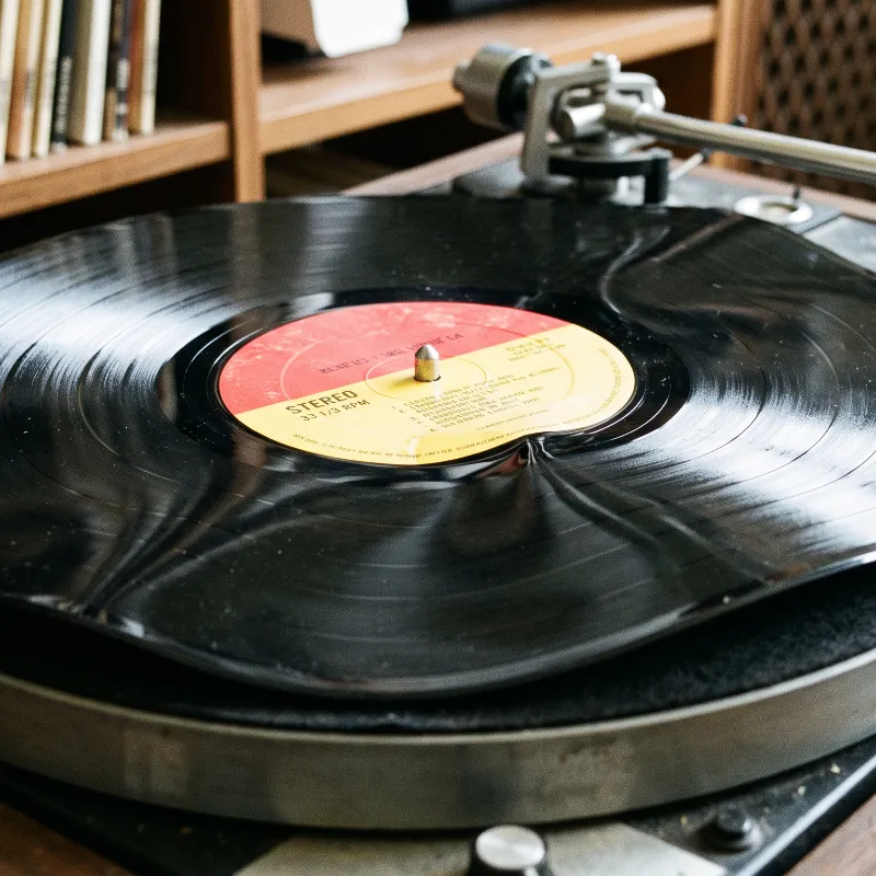 Warped vinyl record undergoing uniform micro-thermal pressure and temperature reshaping